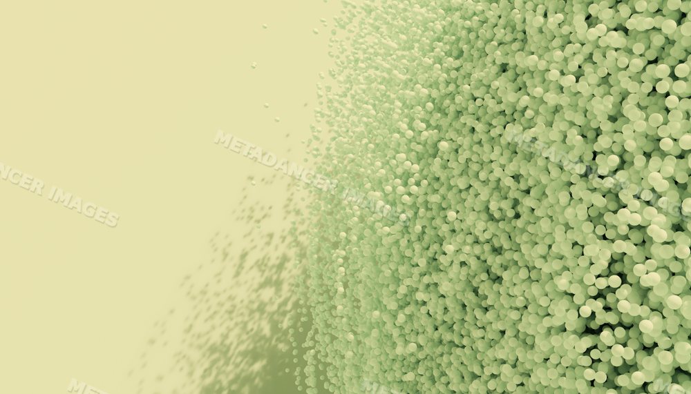 3d rendering of densely packed green spheres with scattered particles