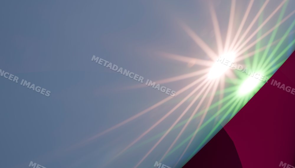 Bright sun flare with lens flare and light beams in a clear sky