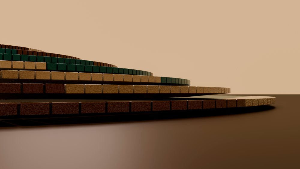 Stacked circular tiers of textured brown and green blocks form an abstract minimalist composition on a brown surface.