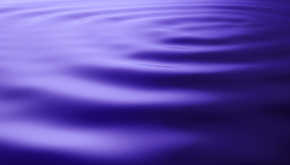Abstract purple water surface with gentle ripples in digital render illustration.