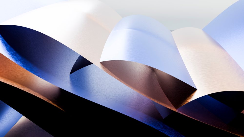 Metallic abstract curved shapes with reflective blue and copper surfaces displayed in a minimalist studio.