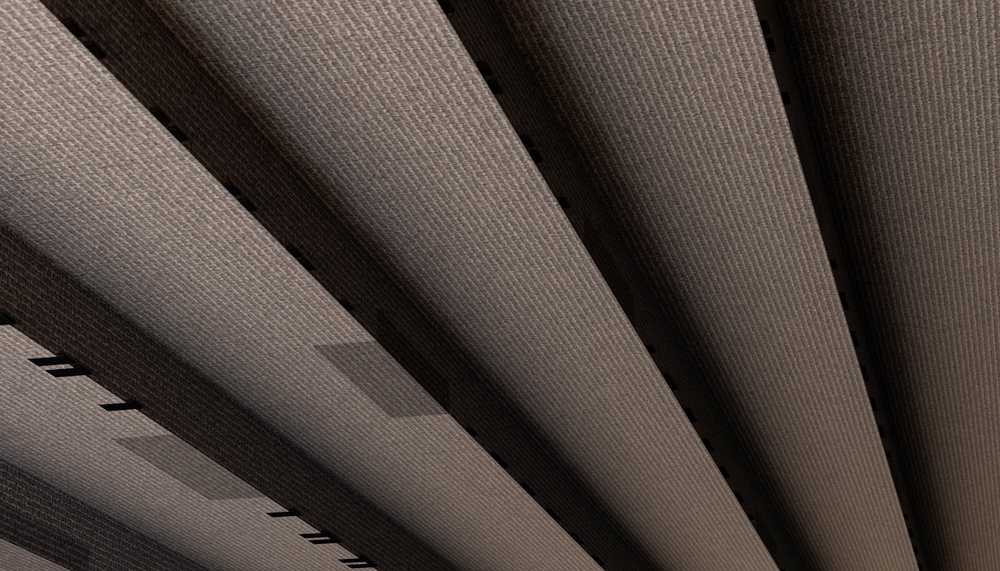 Indoor carpeted stairs feature a modern textured surface with visible stair rail shadows.
