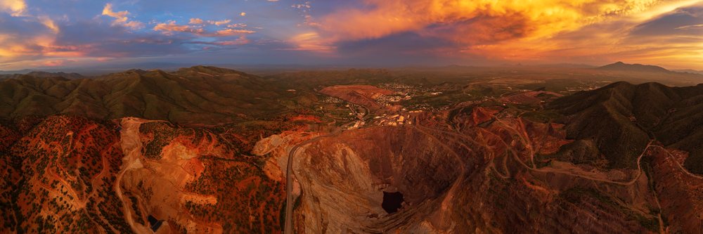 Open pit Copper Mine at sunset with mountainous terrain and a cloudy sky, Storm Chasing, Weather, Environmental Issues, Bisbee, Arizona, USA.
