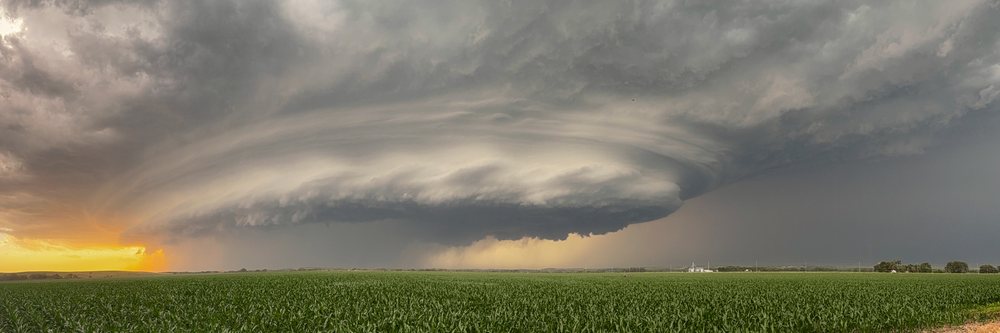 Supercell thunderstorm forming over a cornfield at Sunset in Tornado Alley, Storm Chasing, Ord, Nebraska, USA.