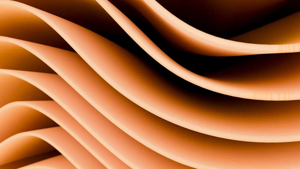 Curved brown paper sheets layered to form an abstract wave pattern with soft shadows and smooth textures.