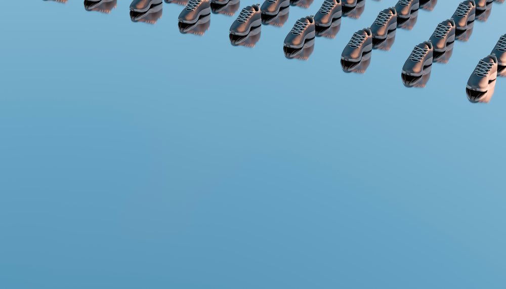 Rows of black shoes arranged in a repetitive pattern on a blue reflective surface.