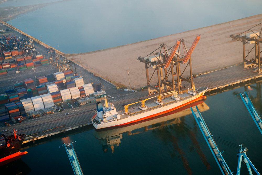 Cargo ship moored at container terminal with shipping cranes and containers at the port in Long Beach, lifornia, Port of Long Beach, CA, USA.