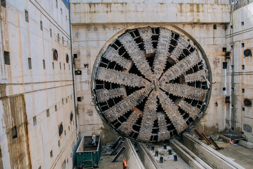 A tunnel boring machine is positioned at a construction site inside a deep excavation, a tunnel boring machine, drilling, USA.