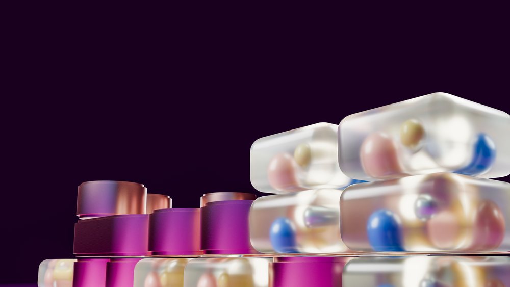 Stacked translucent pharmaceutical capsules containing assorted colorful pills against a dark background in a 3D illustration.