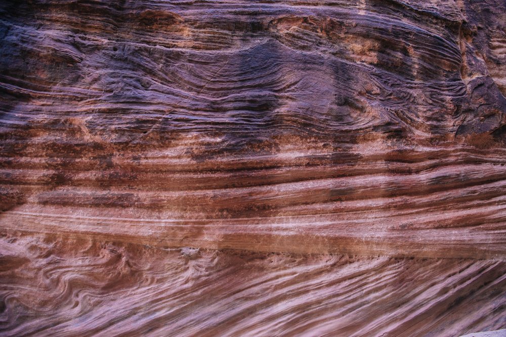 Textured sandstone rock formation with layered geological strata, Buckskin Gulch, slot canyon, Utah, USA.