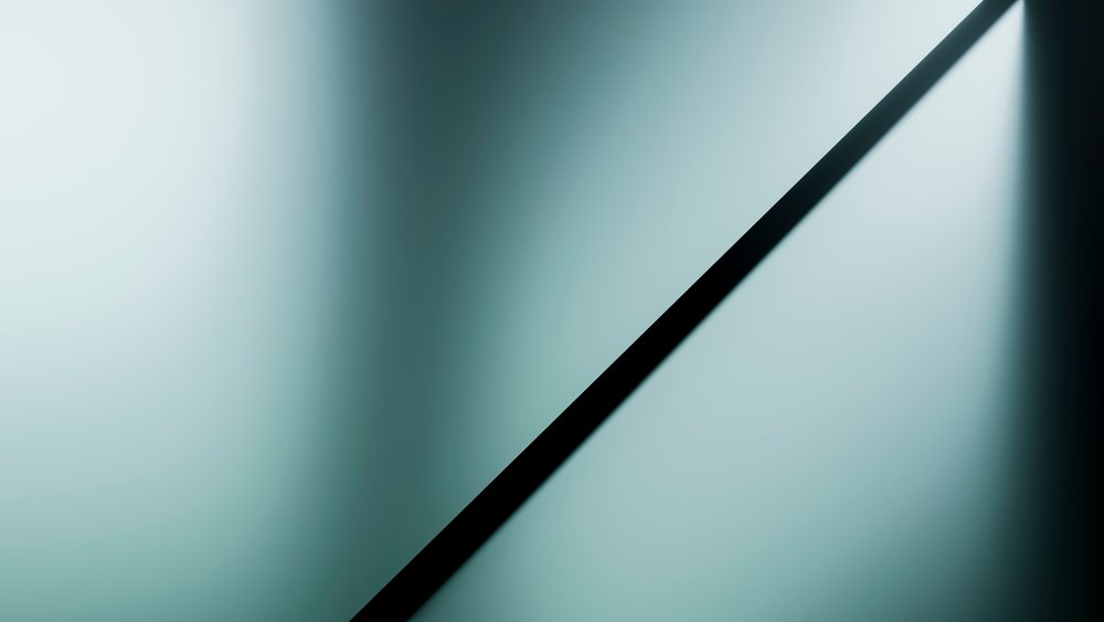 Minimalist abstract geometric triangular shapes and shadows create a pattern on a blue-gray surface.