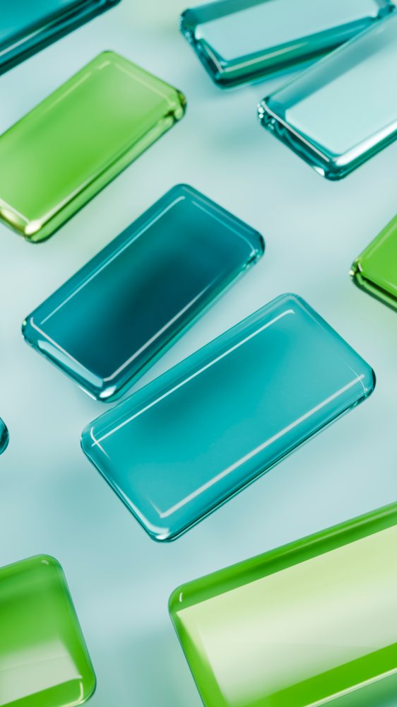 Multiple colorful rectangular glass pieces with smooth edges arranged artistically on a surface under studio lighting.