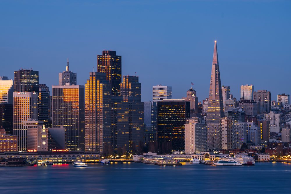 San Francisco city skyline at Dawn showing the Transamerica Pyramid and Ferry Building over the waterfront bay with boats, Cityscapes, City Life, California, USA.