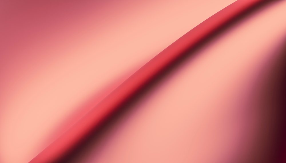 Close-up abstract image of smooth red fabric with soft folds and wrinkles.