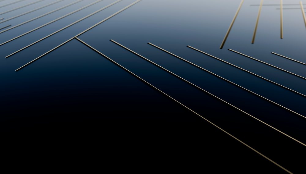 Close-up of metal strings on a dark guitar body showing fine details of the musical instrument.