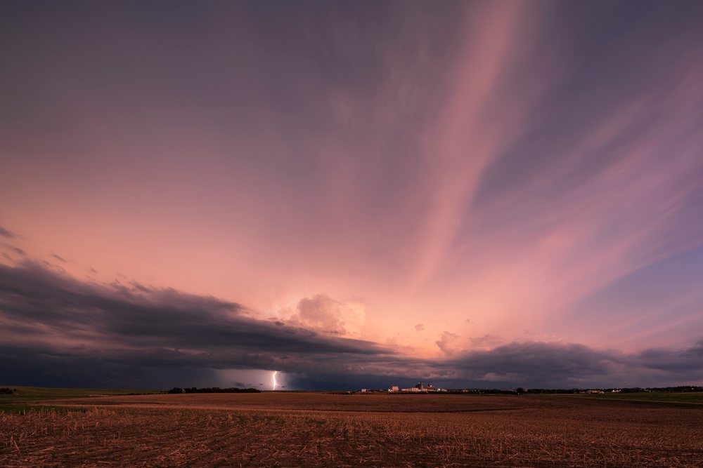 Storm with lightning occurs over open plains and farmland at sunset, Storm Chasing, Weather, Environmental, Winner, South Dakota, USA.