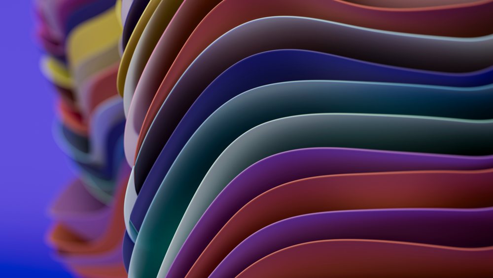 Colorful curved layers forming smooth flowing abstract waves on a purple background.