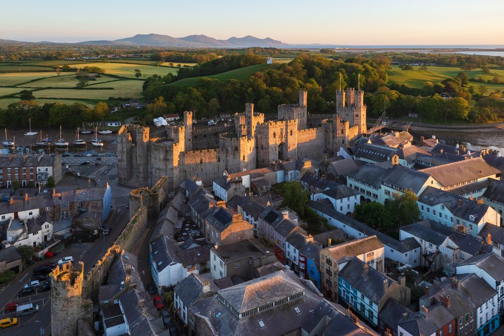 Aerial view of Caernarfon Castle and the walled city, Landscape, Gwynedd, Wales.