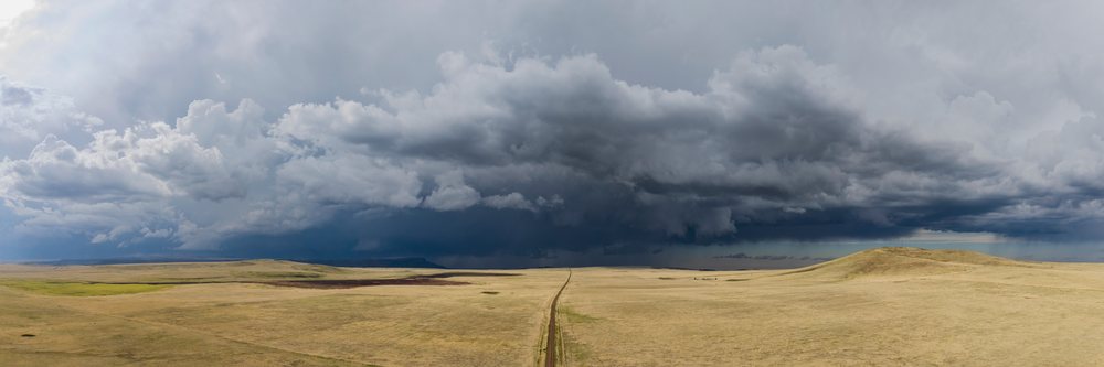 Storm clouds gather over the open grassland at Johnson Mesa in New Mexico's Great Plains, signaling an impending thunderstorm, Storm Chasing, Weather, Environment, USA, Tornado Alley.