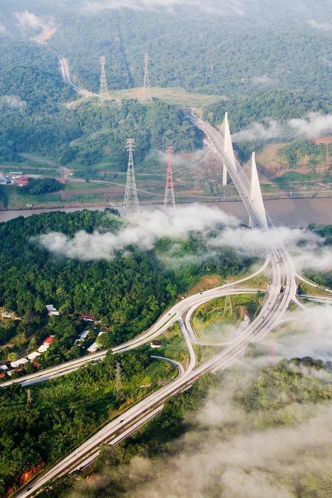 Aerial view of the New Millennium Panama Canal Bridge crossing a river.