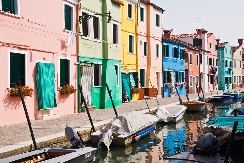 Colorful houses along canal with boats in venice veneto, Italy.