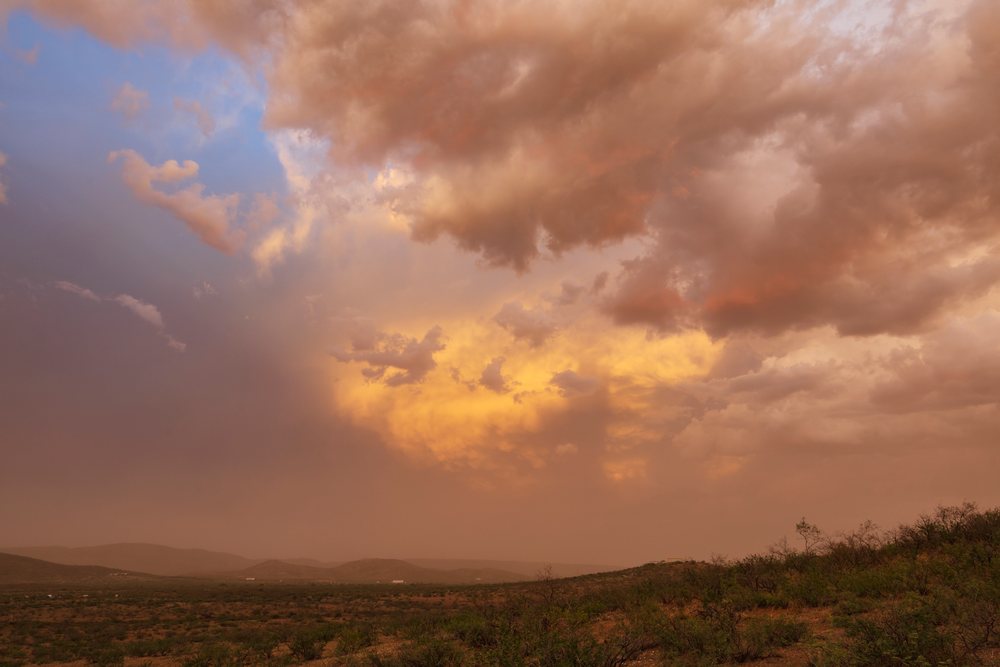Dusty sunset over a desert landscape, with storm outflow and Haboob cloud formation visible, Storm Chasing, Weather, Environmental Issues, Douglas, Arizona, USA.