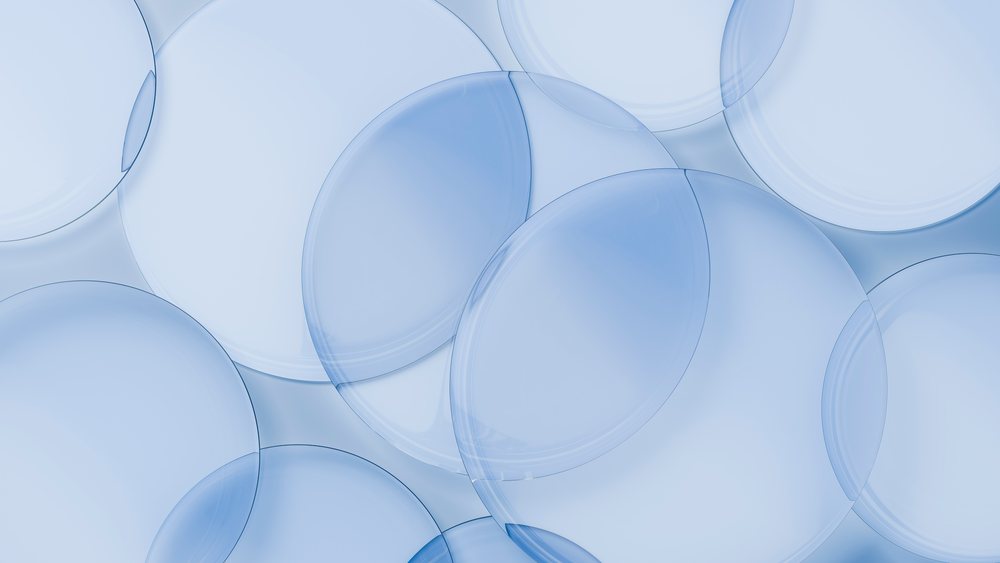 Multiple overlapping semi-transparent blue circles of varying sizes create a modern abstract geometric pattern on a light blue background.