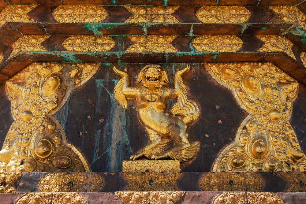 Ornate gold carving of a mythical creature at Darchen Gar Monastery in Kham Tibet, China, Baiyu, Sichuan Province, People's Republic of China.