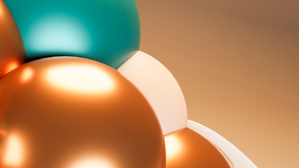 Cluster of orange, teal, and white glossy balloons forming a colorful festive party decoration with reflective highlights.