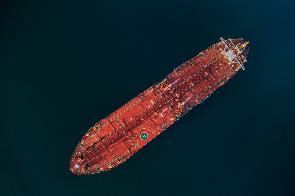 Oil tanker with red deck and helipad seen from above, Port of Long Beach, CA, USA.