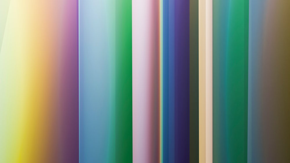 Vertical stripes with gradient colors create a soft abstract background in multiple pastel hues.