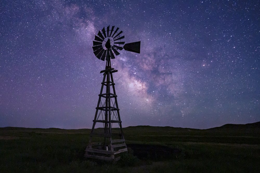 Silhouette of a Windmill under the Milky Way starry night sky in the Great Plains, Storm Chasing, Alliance, Nebraska, USA.