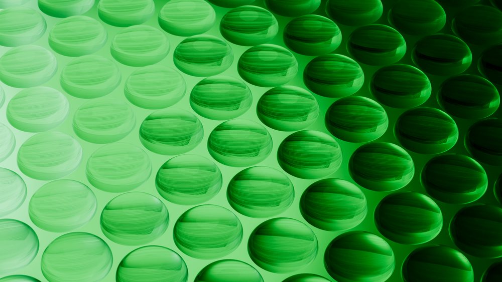 Digital illustration featuring green spheres arranged uniformly in a repeating pattern with gradient shading and smooth glossy texture.