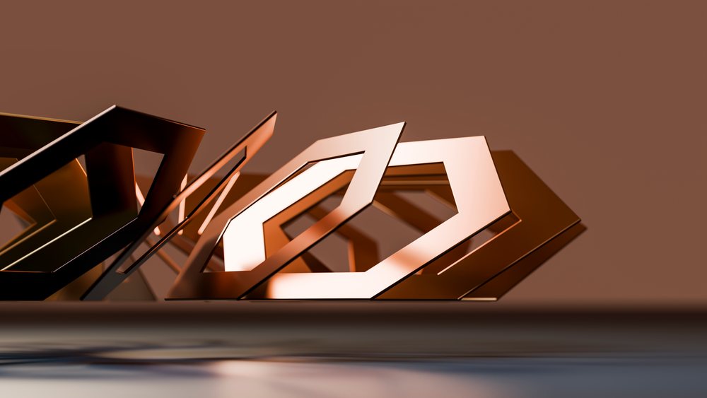 Abstract arrangement of geometric metal hexagon shapes on a reflective surface with a brown background in a studio setting.