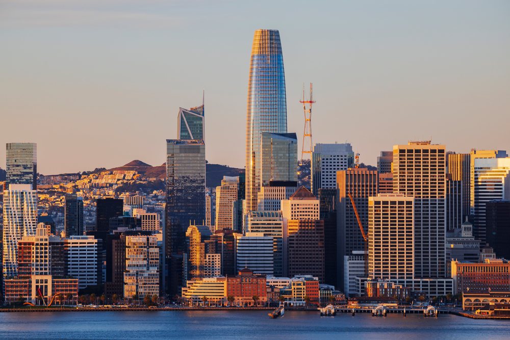 San Francisco skyline at sunset with the Salesforce Building and waterfront reflecting city skyscrapers, Cityscapes, City Life, California, USA.