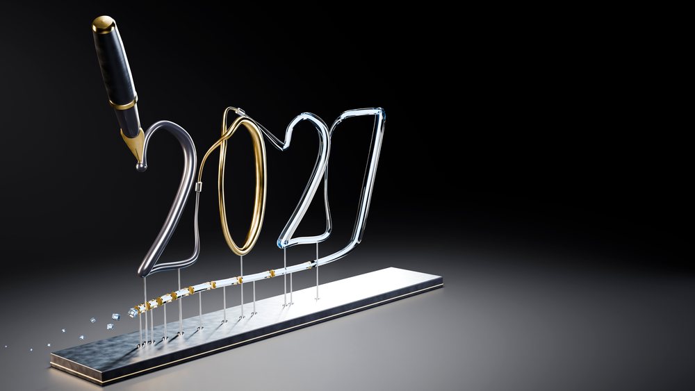 Wire sculpture forming the numbers 2021 with a metallic pen on a metal base against a black background in studio lighting.