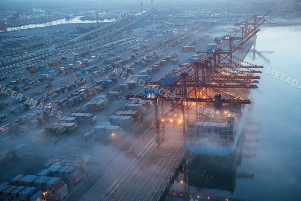 Cargo ship being loaded with containers at a port in Long Beach, CA, USA