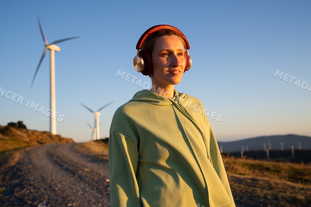 A white woman enjoys music outdoors