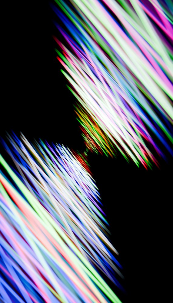 Abstract colorful light streaks with dynamic motion on a dark background create a vibrant digital illustration.