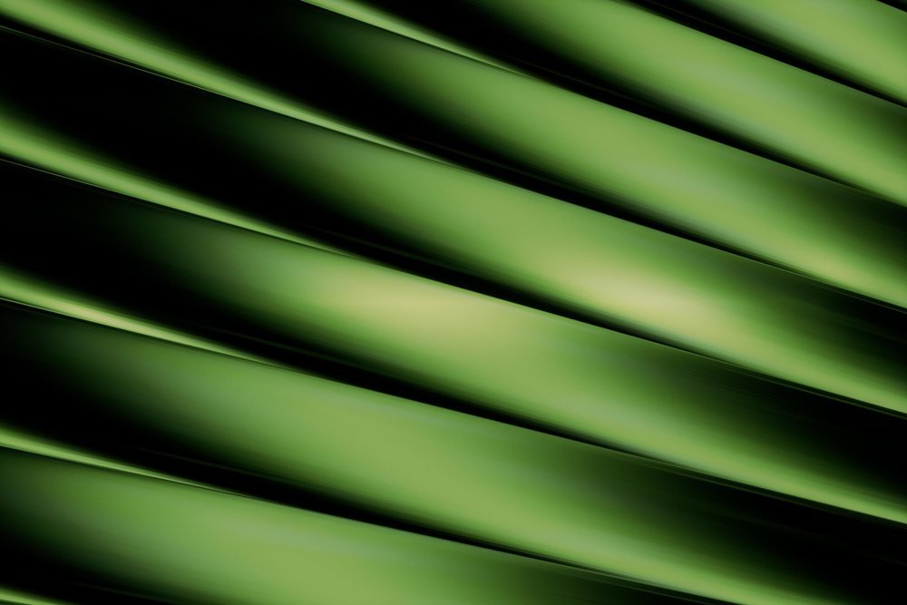 Abstract green background with diagonal gradient lines and smooth textures creating depth through light and shadow.