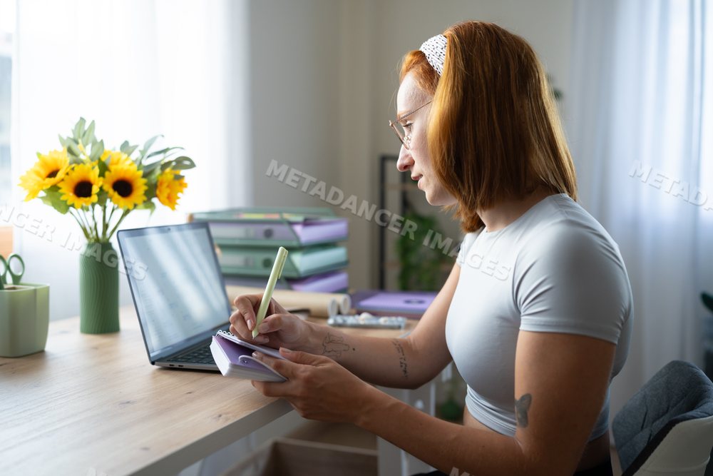 A white woman writing notes