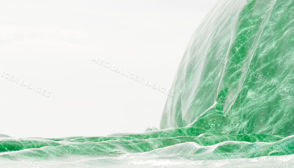 Close-up of a large green ocean wave flowing with white foam