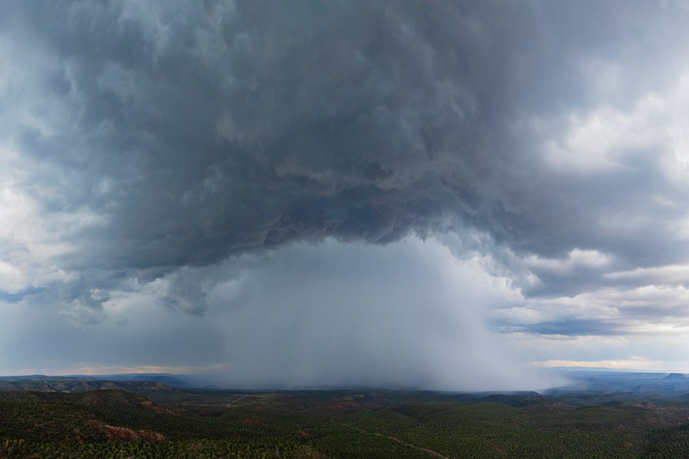 Rain Shaft from a Monsoon Storm over a green forested landscape, Storm Chasing, Weather, Environment, Carrizo, Arizona, USA.