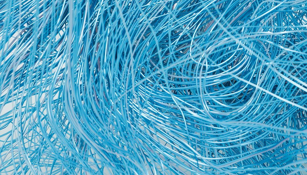 Blue tangled metal wires creating an abstract chaotic pattern.