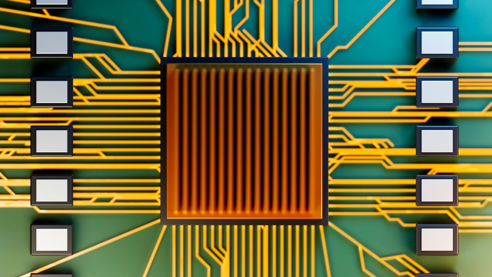 Computer chip mounted on a green circuit board with intricate golden circuitry connections.