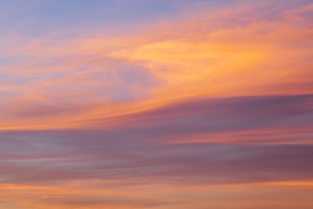 Sunset sky with orange and purple clouds over Erg Lehoudi, Lifestyle, Landscape, Culture, M'hamid, Zagora Province, Morocco.