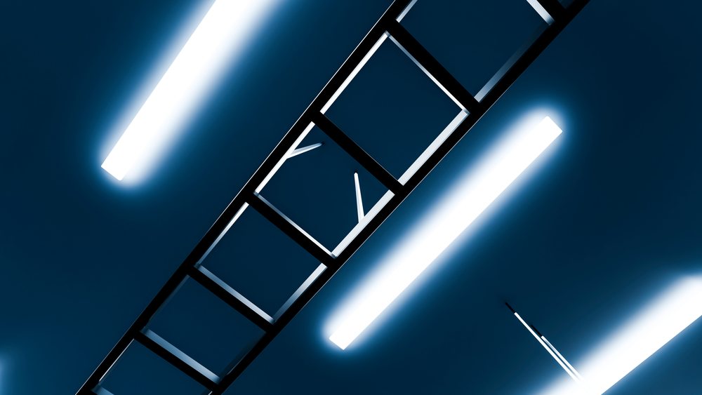 Metal ladder leaned against ceiling illuminated by modern rectangular fluorescent light tubes in a contemporary indoor space.