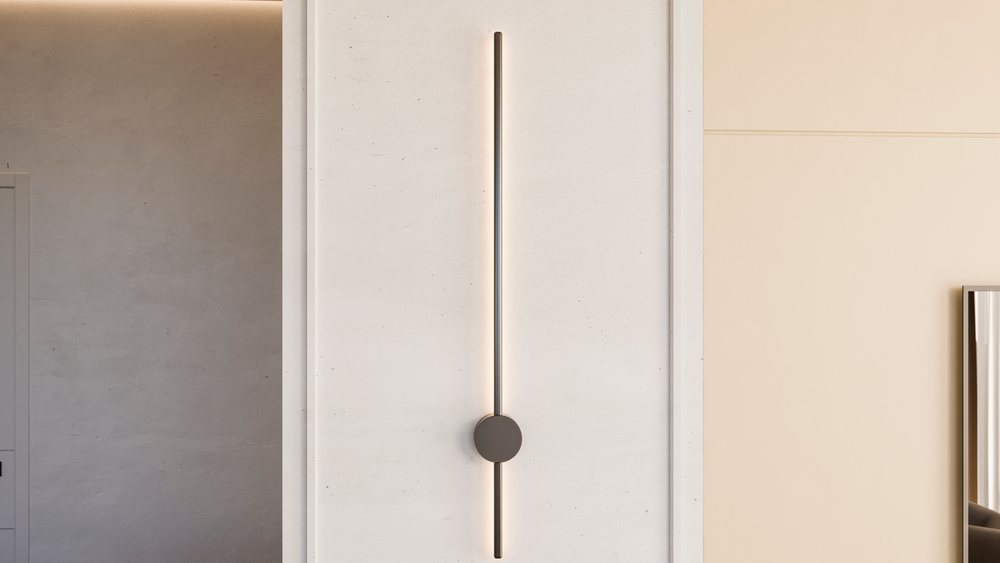 Modern vertical wall lamp emits ambient light on a neutral wall in a contemporary interior space.