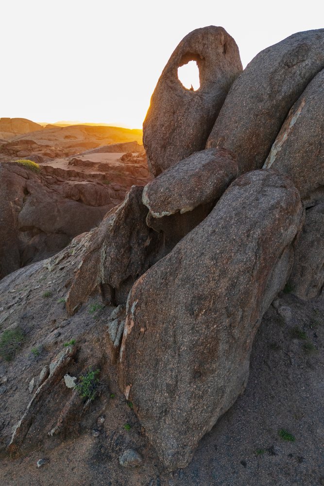 Rock window natural arch in Stone Valley at sunset near Purros in the Kunene Region of, landscape, wildlife, Namibia.