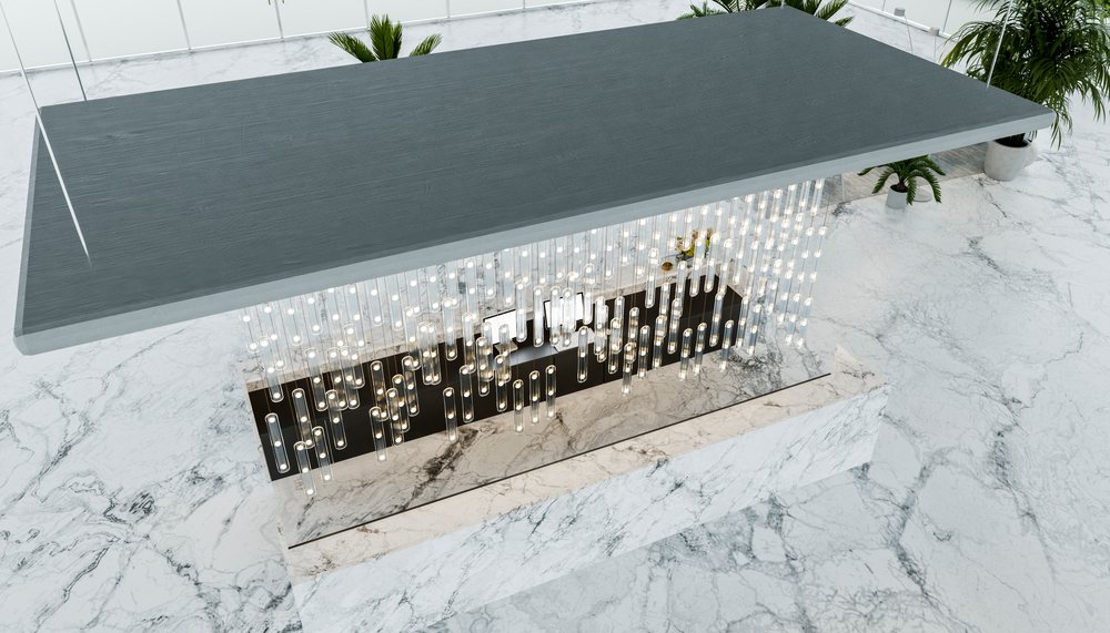 Modern chandelier with multiple glass tube lights suspended over a white marble floor with indoor plants in a minimalist interior design.